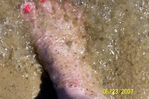Water Rushing Over My Foot - Standing at a beach, where the water meets the sand, I love the feeling of the water rushing over my feet and then the feeling of it receeding and my feet sinking further into the sand.