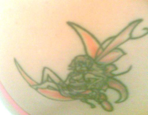 my tattoo - a fairy sitting on a moon on my shoulder. My mom drew the wings. I love my tattoo.