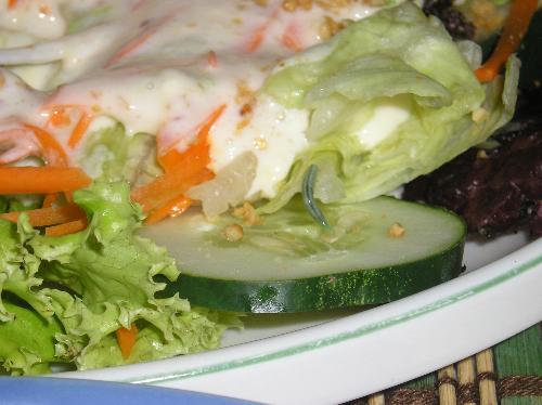caterpillar on salad - a caterpillar crawling on fresh vegetable salad