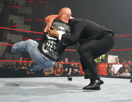 austin in action - stone cold steve austin gives a stunner to donald trump at wrestlemania 23.