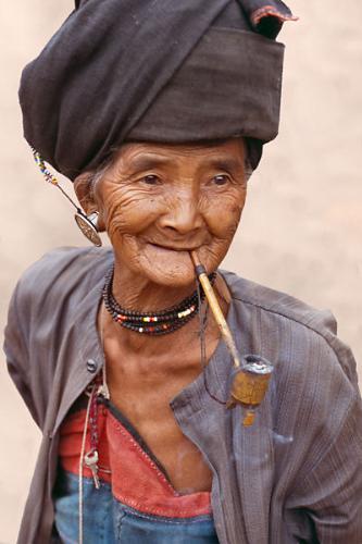 Pipe smoking - An Elderly woman smokng away the day