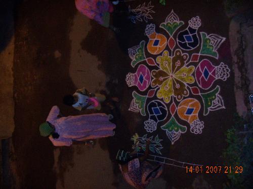 rangoli in my home - On our prime festival Pongal ( practised in Tamilnadu) we did rangoli ...my son very enthusiatic in drawing colours on it..
