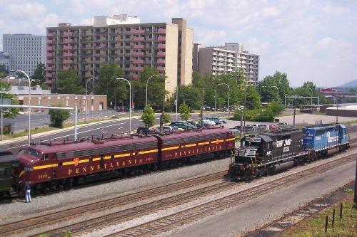 What Era is This??!! - This is actually 07/07/07 and no it's not a doctored photo. This is Altoona, PA. Pennsylvania E8 locomotives #5809 amd #5711 (owned and repainted by Norfolk Southern to their original attire) are pulling an excursion run of Septa and restored Pennsy cars around the Horseshoe Curve on a sunny Saturday. The Norfolk Southern and Conrail combo is a set of helpers ready to push an oncoming freight up the Allegheny mountains.