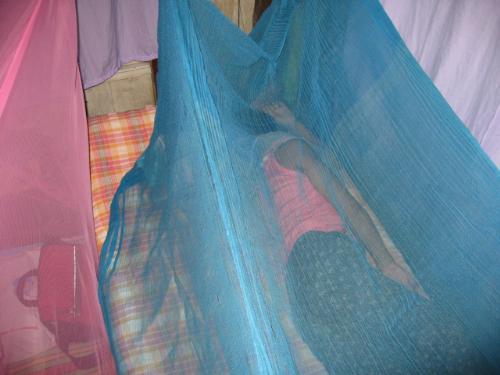 Sleeping - Sleeping under a mosquito net Sleeping - Sleeping under a mosquito net
