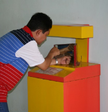 A man in the Science Centrum - This is a picture of a man trying out something at the Sciene centrum. He looks really interested because science is indeed one great field that is almost a twin of magic.