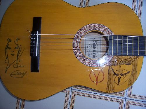 My classic guitar - My classic guitar On the left there is a the sign and draw by El Tofo, the singer of Tre Allegri Ragazzi Morti, an italian rock band. On the right a design by me.