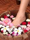 foot spa - foot soaked in bath filled with fresh flowers