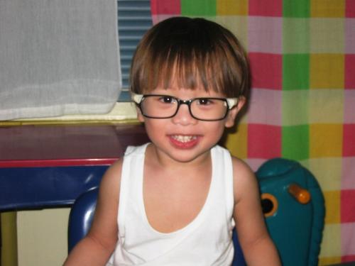 my son - This is my son wearing the old eyeglasses of his Dad, minus the lenses of course.