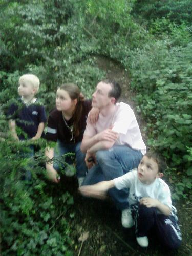 my 2 sons, hubby and step daughter,  - we went to a park near our house, when we walked amoung the trees alot of birds were chirping so they all bent down to listen, good job i had my camera on hand as this pic is lovely, what do you think?