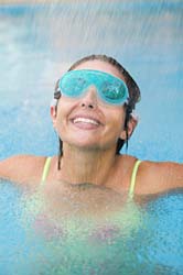 swim in the rain - a woman swimming with goggles in the rain