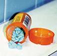 Addiction - A bottle of adderall (a mind altering amphetamine) spilled out on a table