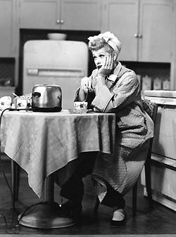 Lucy in jammies at the table - This picture reminds me of me lol.