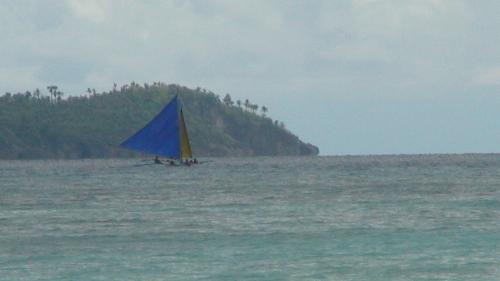 sailing at the beach - a simple photo of a sailboat. i just loved the blue sail.
