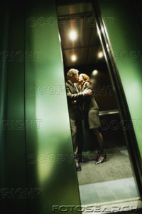 kissing - A couple kissing in an elevator