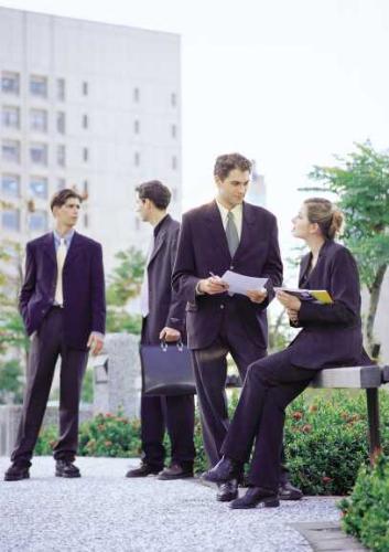Workers - Four workers dressed up in formal attire outside the office to discuss policy issues concerning disability.