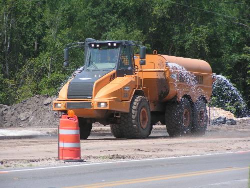 Water Tanker - This is one of the many pieces of heavy equipment that are busy making four lanes out of our two lane highway. I am fascinated watching them work. Water Tanker - This is one of the many pieces of heavy equipment that are busy making four lanes out of our two lane highway. I am fascinated watching them work.