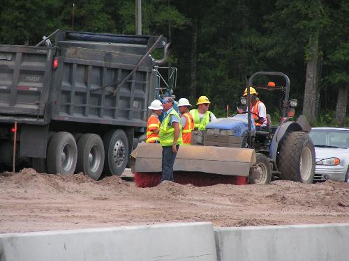 Road crew at work - I saw the crowd of men talking while it looked like only one guy was working. I thought it was kind of funny, so I snapped a picture of it. Road crew at work - I saw the crowd of men talking while it looked like only one guy was working. I thought it was kind of funny, so I snapped a picture of it.