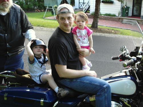 Daddy, Mackenzie, and Lenny sitting on a Harley Da - My (Mrs_Lidwell's) son, Lenny, daughter, Mackenzie, and husband, Leo... all sitting on Lennys harley davidson! My father in law rides it... it is in both my father in law's name AND my son's name. We named my son after my father in law!