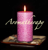 candle - Magenta palm tree wax candle burning amongst rocks on ceramic candle container.