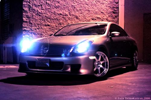 2005 Nissan Skyline GT-R - Silver 2005 Nissan Skyline GT-R with blue HIDs of front driver's side parked in lot at night