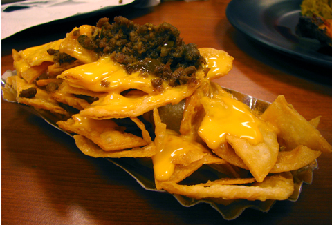nachos - crunchy nachos topped with creamy cheese and beef bits