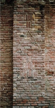 Mysterious Markings on Old Brick Wall - Depicts triangular markings on section of brick wall saved from demolition.
