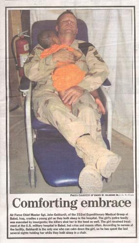 American Soldier and Iraqi Baby - American soldier showing compaion to a little Iraqi child.