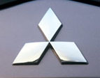 Chrome Mitsubishi Logo Front Emblem on Black Car - Chrome Mitsubishi logo front emblem on black clear-coated car