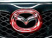 Red chrome Mazda front logo emblem - Red chrome Mazda front logo emblem on black grille of SUV