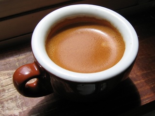 A demitasse of espresso - A demitasse of espresso - brown cup and double shot.