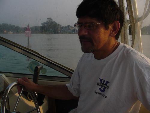 my dad - my dad driving are boat, afterwards we went fishing, me catching one fish my dad catching 3. His shirt says nicaragua or something but he is from paraguay. He went on a missions trip to nicaraguay a while back.