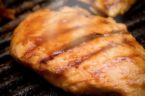 grilled chicken - Golden-brown chicken still steaming on the grill.