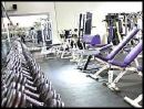 gym - a gym with a mirror and weights and stuff
