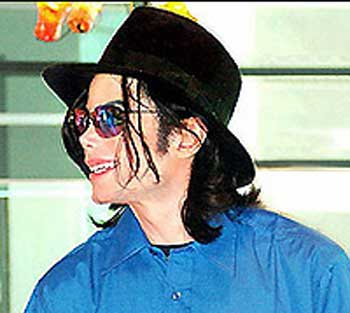 mj  - Micheal Jackson on a stage show in dubair wearing googles and blue shirt