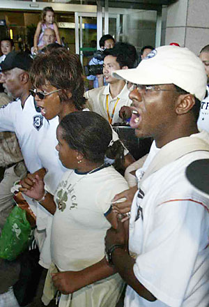 whitney houston - Her family arrived in shanghai airport.