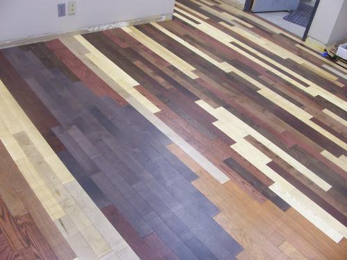 Custom Hardwood - Random Selection of various species and stains of engineered hardwood installed in office with custom random patterns.