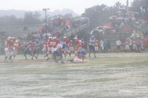 Football in the rain - In this shot you can see the water standing in the field and how hard it is raining.