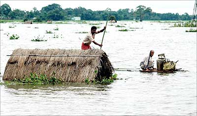 water go to roof - Water reaching to roof of houses in villages of a flooded are.