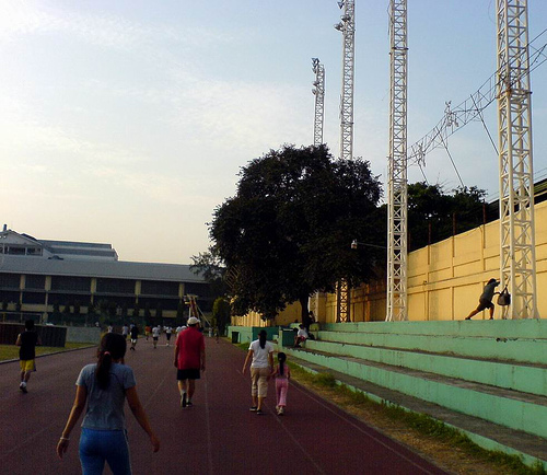 people jogging - cebu city sports complex oval with people jogging