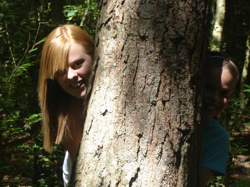 Sarah and Lauren Behind a Tree - Hiding behind a tree in St. Leonards Forest