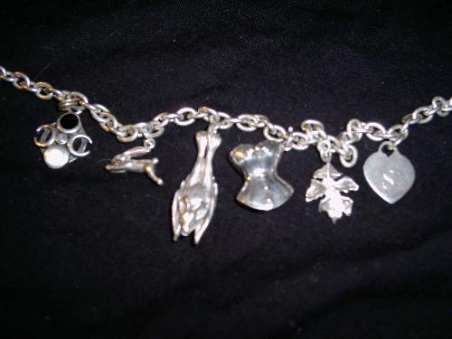 my charm anklet - featuring an enamel charm showing the moon phases, a hare, a bat, a corset, an oak leaf, a heart with mine and my partners initials either side.   I have a borage flower to put on still, and a witch on a broomstick who fell off and needs to be put back on