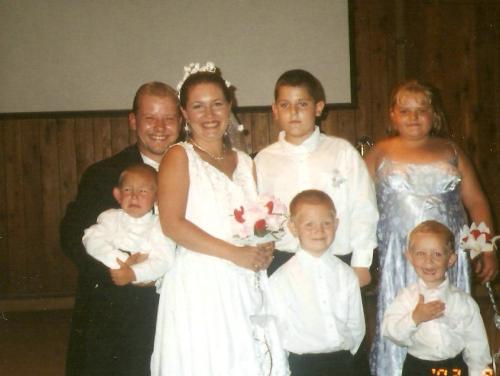 one big happy family - after we said our i dos had to do the jpicture thing..lol.. check out the two younger boys. One is crying because his feet hurt and is way too hot, and the other one is just too excited because his mommy got married... i love it they make the picture....