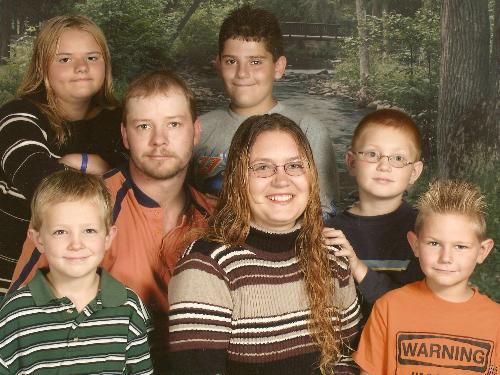 family picture time - this is my family... from left to right.. my son curtis, my husband jamie, my step daughter michelle,my step son cristian, my son collin, me and my step son jeramy...of course dad dont like his picture taken.... cant you tell...lol
