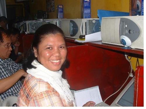 internet training hands-on - a confident pose with charm of ms. fe p. ortega during internet training hands-on in one internet cafe in cagayan de oro city, philippines. it was an exciting moment together with other participants nationwide having linked with each other through the groove.