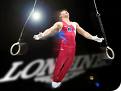 male gymnast - photo of a male gymnast dismounting from the rings