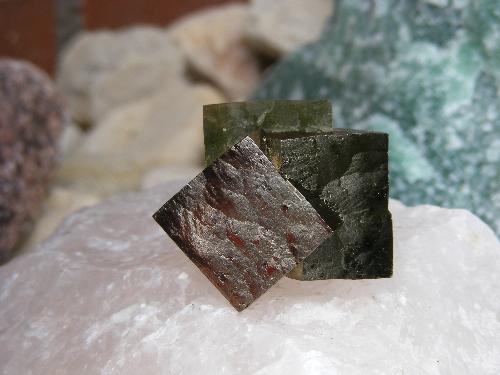 3 pyrite cubes in 1 - The pyrite cube from Spain was taken a shot of on a big piece of a rose quartz, and on the site is a big piece of green quartz from Brazilia