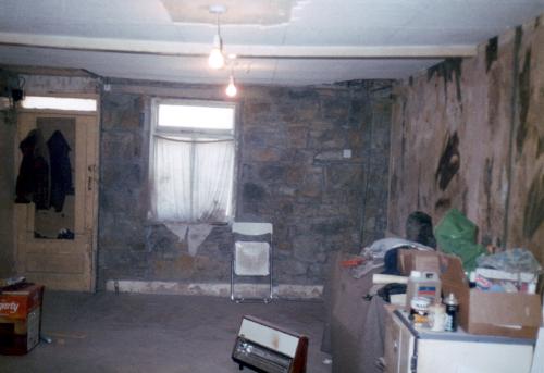 Living Area - This is the sitting room before renovations. The ceiling beam was bending under the weight of the floor above.