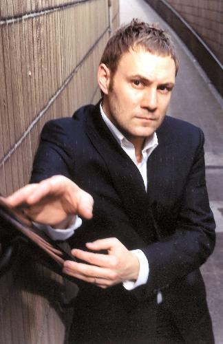 David Gray - David Gray holding the handrail of a stairwell