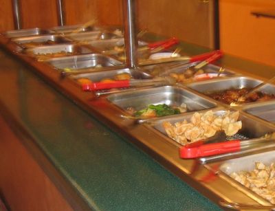 typical buffet - This is a typical set-up of a restaurant buffet table. nice to have the sneeze guards in place to ward off respiratory borne illnesses, but what about hand to hand transfers by using the same utensils over and over person to person?`