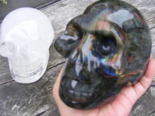 Elie the new labradorite skull - On the photo and in my hand is Elie, the new labradorite skull, and the crystal quartz skull on the table is Jolly Zee. Both skulls have spent more than a year with Synergy, the Ancient skull.